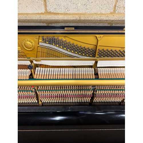 51 - Yamaha (c1977)A Model U1 upright piano in a bright ebonised case; together with a stool. AMENDMENT I... 