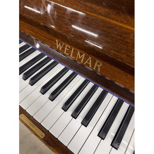 63 - Welmar (c1997)An upright piano in a traditional bright mahogany case; together with a stool.