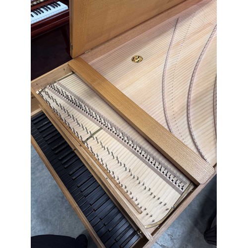 87 - HarpsichordA 7ft modern harpsichord in a light oak case supported on square sectioned legs. AMENDMEN... 