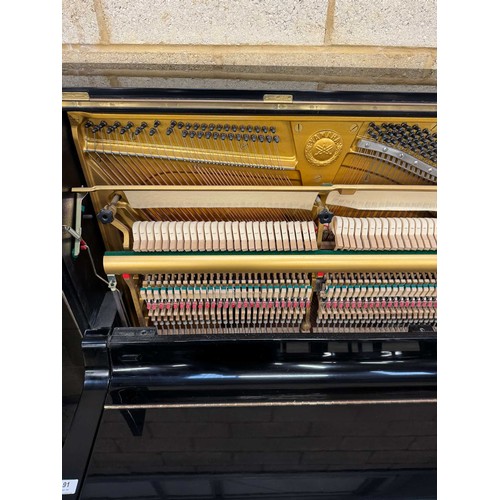 91 - Yamaha (c1982) A Model U3A upright piano in a traditional bright ebonised case.