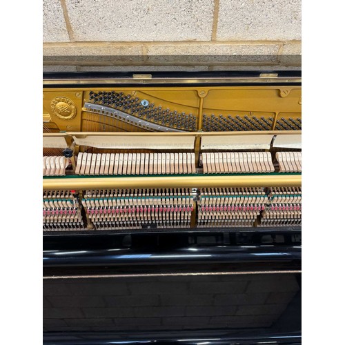 91 - Yamaha (c1982) A Model U3A upright piano in a traditional bright ebonised case.