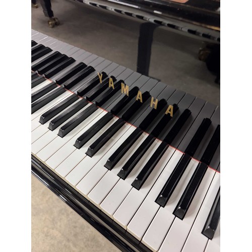 92 - Yamaha (c1975)A 5ft 7in Model G2 grand piano in a bright ebonised case on square tapered legs; toget... 