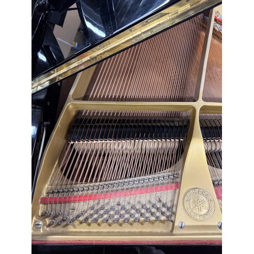 92 - Yamaha (c1975)A 5ft 7in Model G2 grand piano in a bright ebonised case on square tapered legs; toget... 