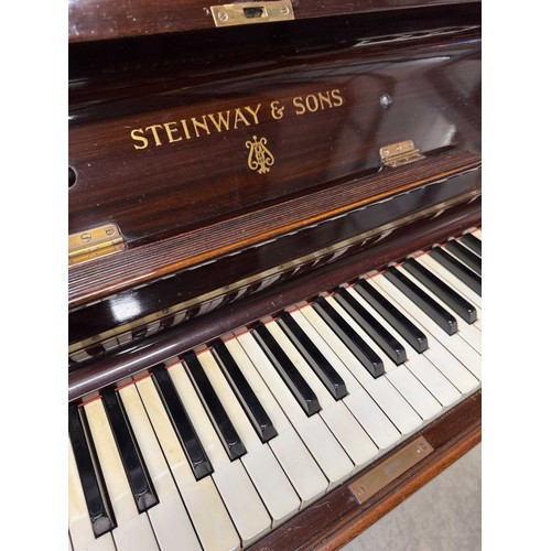 94 - Steinway (c1929)A Model K upright piano in a mahogany case; together with a stool. IRN: JLJP16HS... 