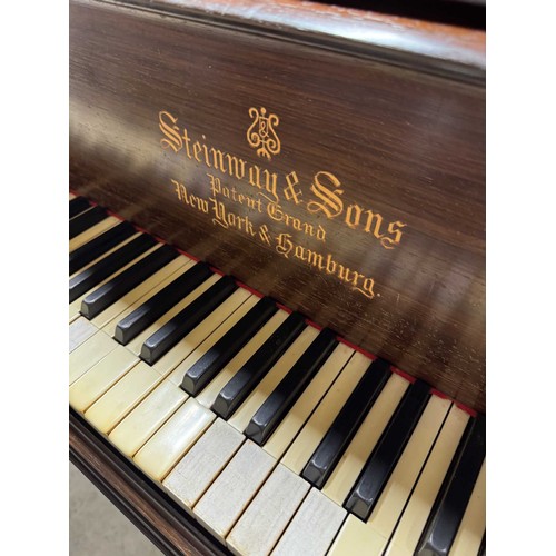 96 - Steinway (c1910)A 5ft 10in Model O grand piano in a rosewood case on square tapered legs; mounted on... 