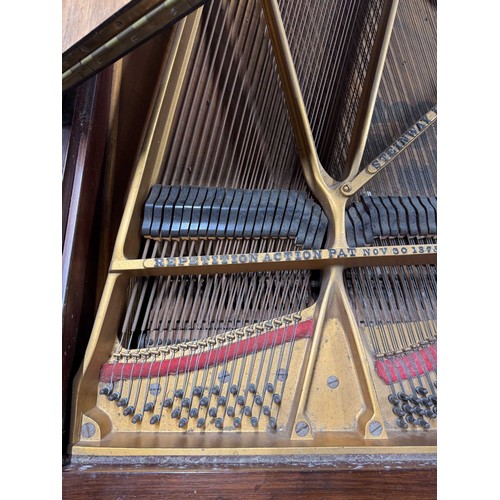 96 - Steinway (c1910)A 5ft 10in Model O grand piano in a rosewood case on square tapered legs; mounted on... 