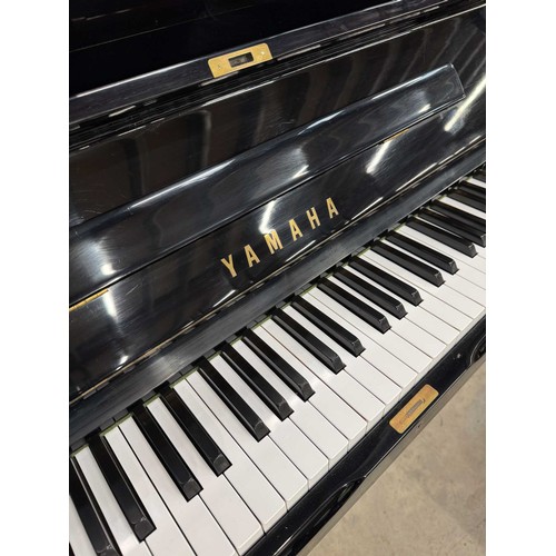 101 - Yamaha (c1975)A Model U1 upright piano in a bright ebonised case; together with a matching adjustabl... 