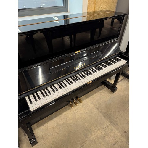 101 - Yamaha (c1975)A Model U1 upright piano in a bright ebonised case; together with a matching adjustabl... 