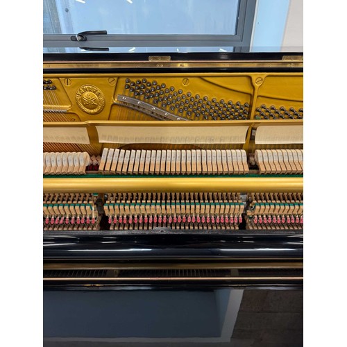 101 - Yamaha (c1975)A Model U1 upright piano in a bright ebonised case; together with a matching adjustabl... 