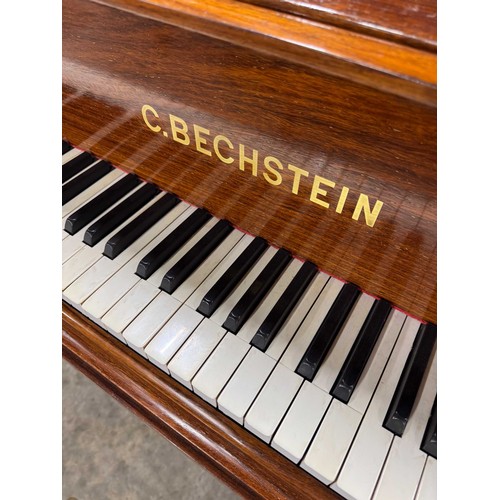 107 - Bechstein (c1904)A 6ft 7in Model B grand piano in a rosewood case on dual square tapered legs; toget... 