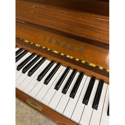 115 - Yamaha (c1989)A Model U1 upright piano in a traditional satin walnut case; together with a duet stoo... 