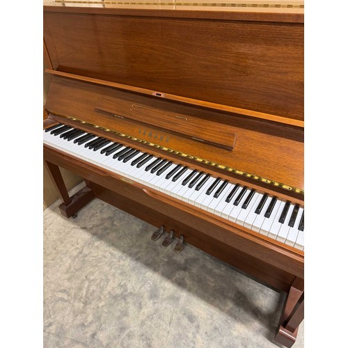 115 - Yamaha (c1989)A Model U1 upright piano in a traditional satin walnut case; together with a duet stoo... 