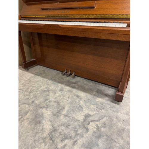 115 - Yamaha (c1989)A Model U1 upright piano in a traditional satin walnut case; together with a duet stoo... 