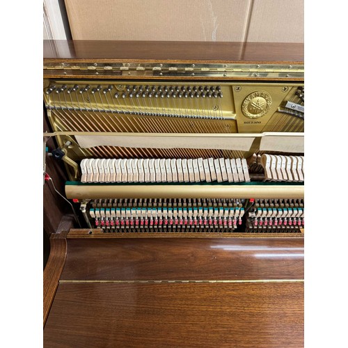 115 - Yamaha (c1989)A Model U1 upright piano in a traditional satin walnut case; together with a duet stoo... 