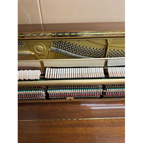 115 - Yamaha (c1989)A Model U1 upright piano in a traditional satin walnut case; together with a duet stoo... 