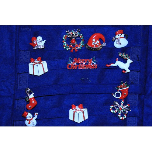 21 - Jewellery Wrap with a selection of 20 Xmas Brooches