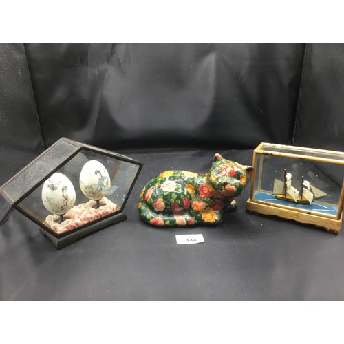 144 - Cased Ship, Cased Chinese Painted Eggs and a Ceramic Cat