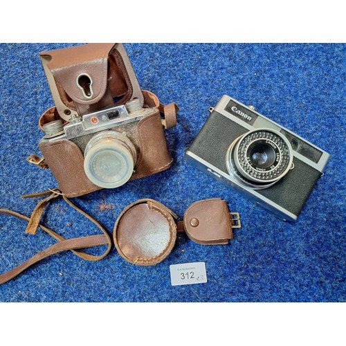 312 - Vintage Canon Junior and Cased Halina Camera With Lens Covers