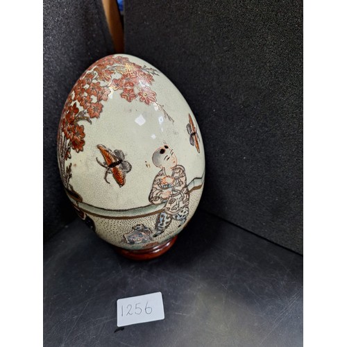 1256 - Japanese Ceramic Hand Painted and Guilded Egg On a Stand