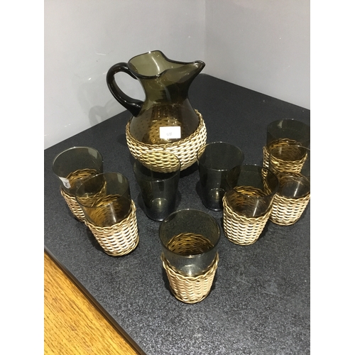 69 - Basket Weaved Smoked Glass Pitcher and 8 Glasses