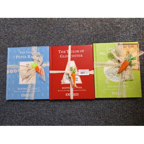 691 - Carrot Wrapped Beatrix Potter Books x9