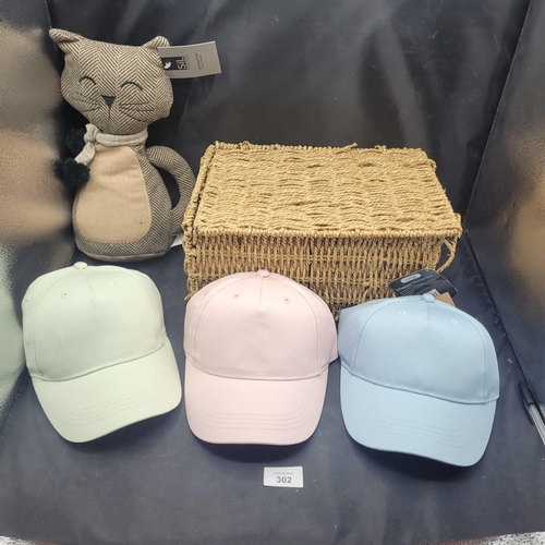 302 - An Assortment of Household Accessories, including a Cat Doorstop, Seagrass Basket, and Three Basebal... 