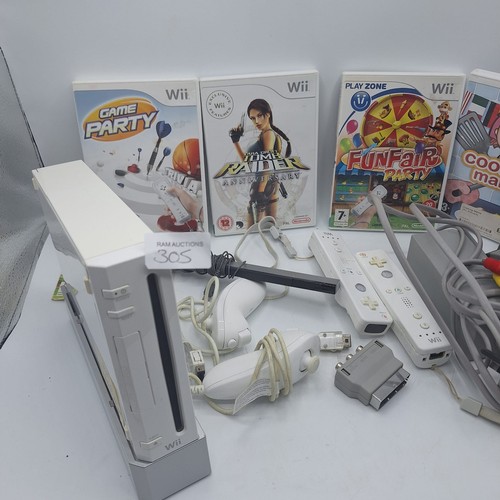 305 - WII CONSOLE AND 4 CONTROLLERS, LEADS. STAND ETC AND5 GAMES