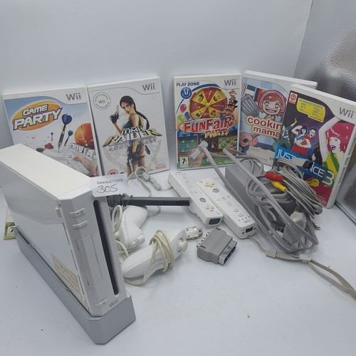 305 - WII CONSOLE AND 4 CONTROLLERS, LEADS. STAND ETC AND5 GAMES