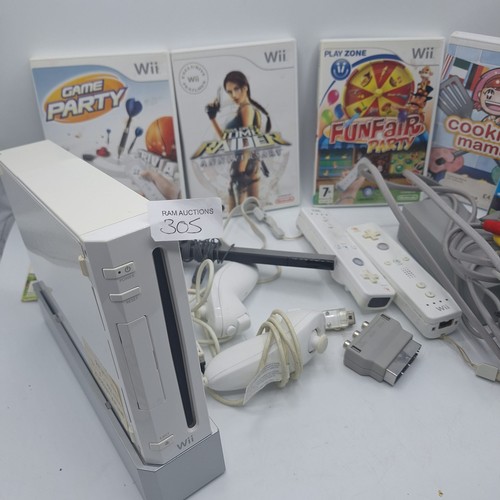 305 - WII CONSOLE AND 4 CONTROLLERS, LEADS. STAND ETC AND5 GAMES