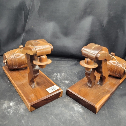 13 - A Pair of Mid-Century Stylized Ecuadorian Wood Folk Art Man Pulling Barrel Bookends