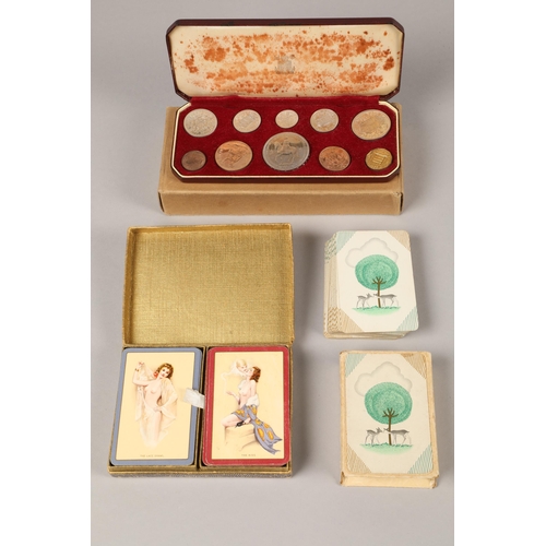 A Queen Elizabeth Royal Mint Coronation proof set; together a pack of Goodall's Boudoir erotic playing cards and one other