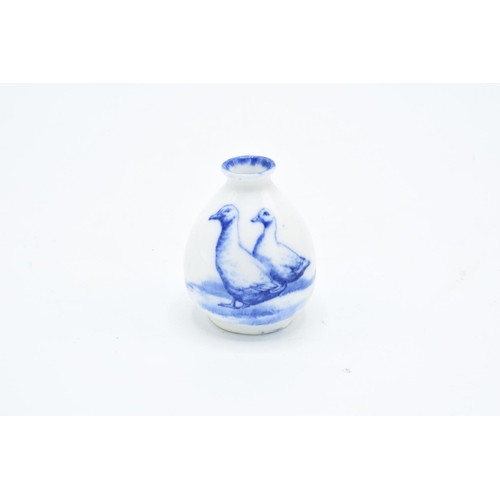 114 - Royal Doulton miniature blue and white vase with a bird scene