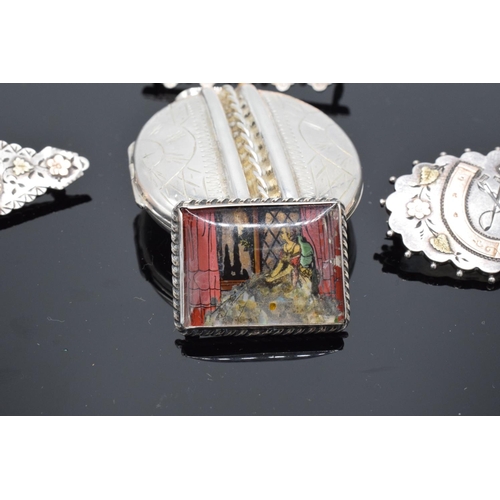 236 - A collection of Victorian silver brooches and a large silver lockett (5) (36.1 grams)
