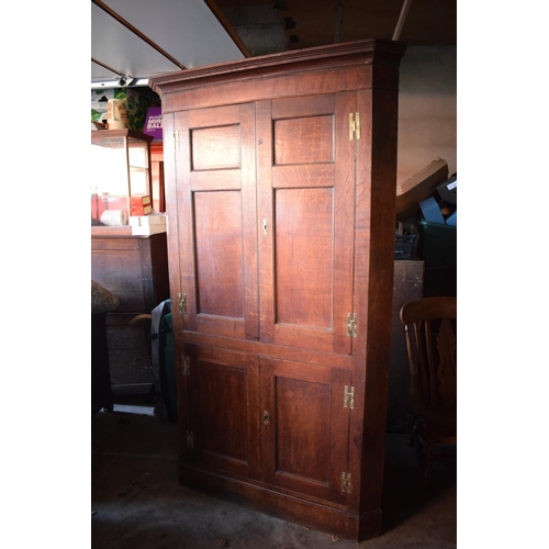 335 - Georgian large 4 door oak self standing corner cabinet with original brass hinges