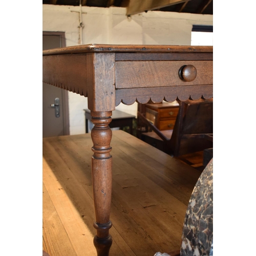 349 - Late Victorian oak kitchen table with boarded top with lobed apron piece turned legs with folding si... 