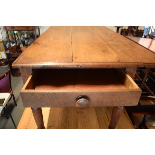 349 - Late Victorian oak kitchen table with boarded top with lobed apron piece turned legs with folding si... 