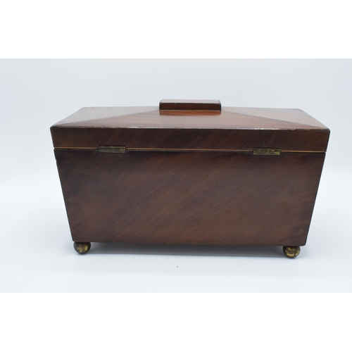 108 - 19th century mahogany tea caddy in a sarcophagus form mounted on brass ball feet. In good condition ... 