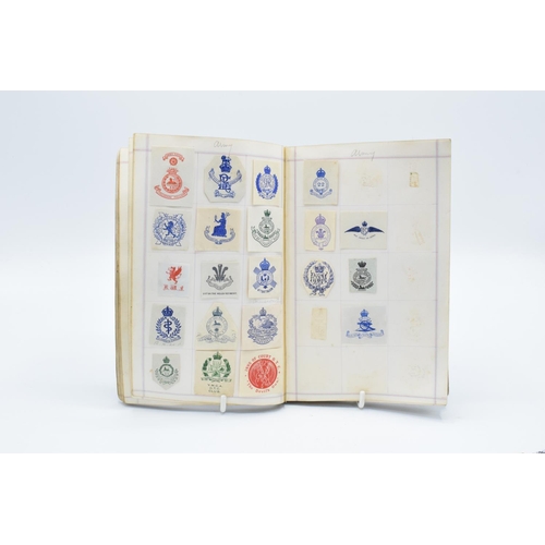 198 - Antique crest book to include crests from: MPs, Royalty and famous figures, hotels, schools, militar... 