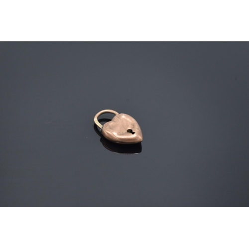 207 - 9ct rose gold heart-shaped lock/ pendant: 1.1 grams, Misshaped