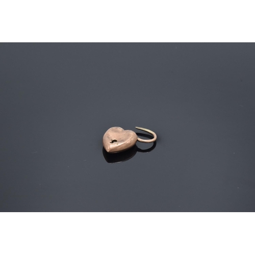 207 - 9ct rose gold heart-shaped lock/ pendant: 1.1 grams, Misshaped