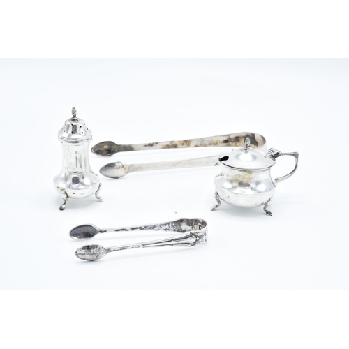 231 - A mixed collection of silver including Georgian tongs, one smaller pair, a cruet pot and a pepper po... 