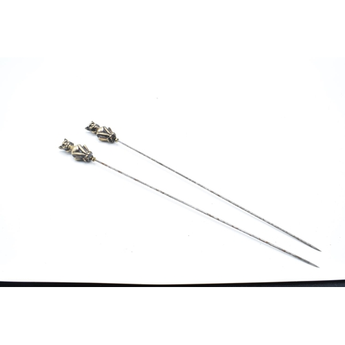 255 - Pair of Victorian brass and steel cat hatpins, 22cm long