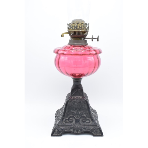 273 - Victorian cranberry oil lamp with a later chimney. Untested condition. Some damage to metalwork. See... 