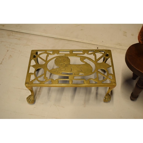 279 - A mixed collection of items to include: copper tea pot, brass lion trivet and a wooden Childs stool ... 