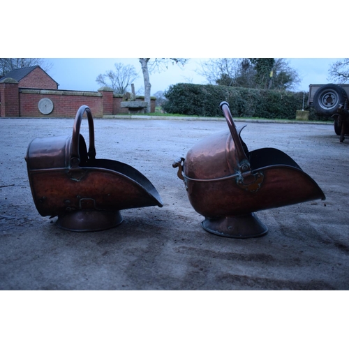 280 - 2 Victorian copper helmet coal scuttles. The floor has started to disintegrate in one example. The b... 