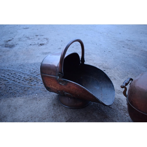 280 - 2 Victorian copper helmet coal scuttles. The floor has started to disintegrate in one example. The b... 