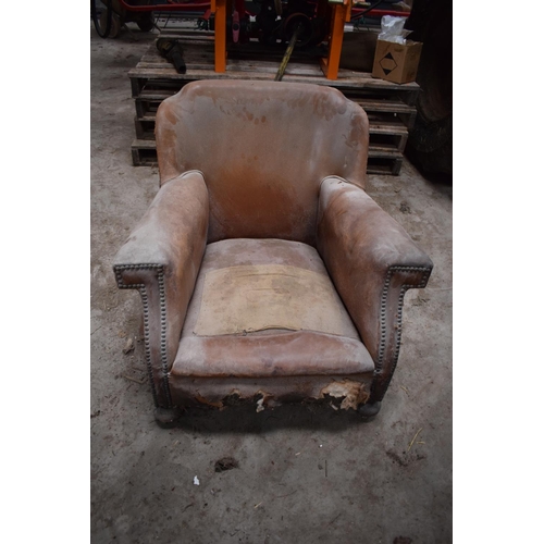 299 - Early 20th century French tan leather armchairs. Both in a poor state of condition with both in need... 