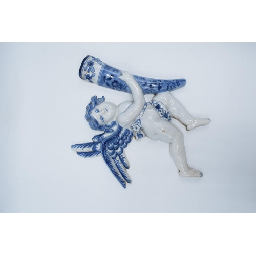 47 - English 19th century Delft model of a cherub holding a cornucopia in a tin glaze. Some chipping to t... 