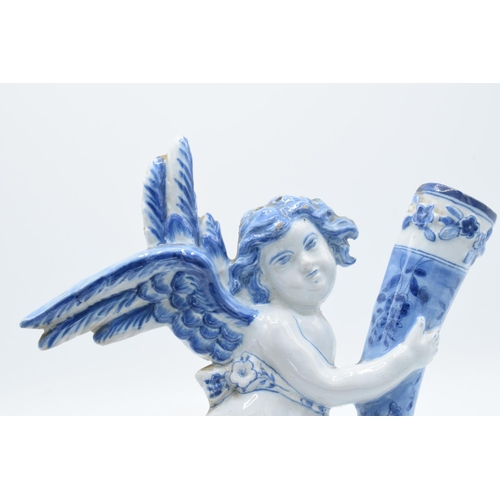 47 - English 19th century Delft model of a cherub holding a cornucopia in a tin glaze. Some chipping to t... 