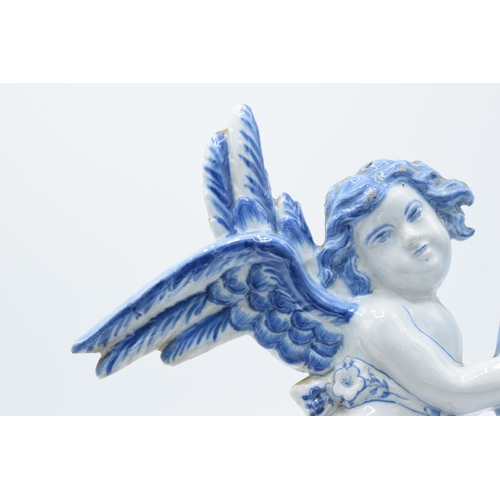 47 - English 19th century Delft model of a cherub holding a cornucopia in a tin glaze. Some chipping to t... 